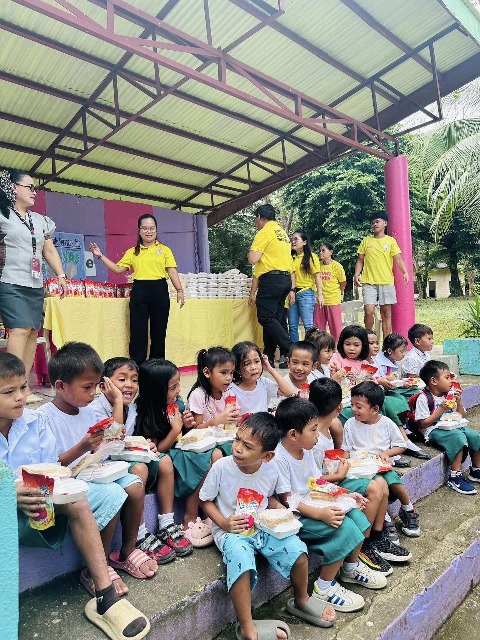 Children enjoying meals at a Helping Hands feeding program