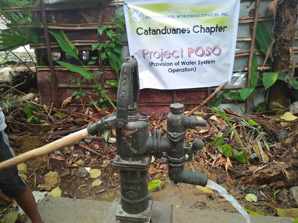 A Project POSO hand pump delivering clean water to a community